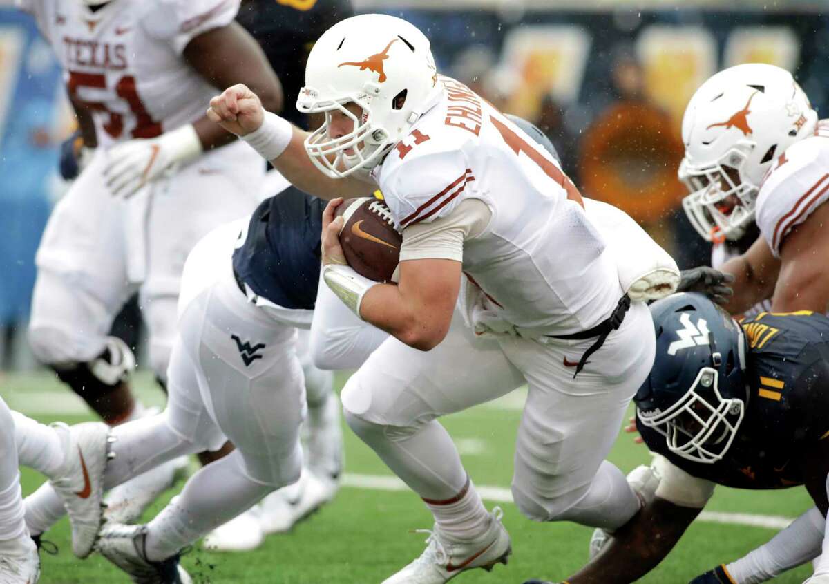 Texas quarterback Sam Ehlinger (11) is tackled by West Virginia linebacker David Long Jr. (11) during the first half of an NCAA college football game, Saturday, Nov. 18, 2017, in Morgantown, W.Va. (AP Photo/Raymond Thompson)