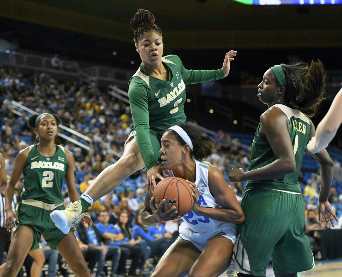 Baylor's Trinity Oliver, top, bites on a fake by UCLA's Monique Billings during the first half.