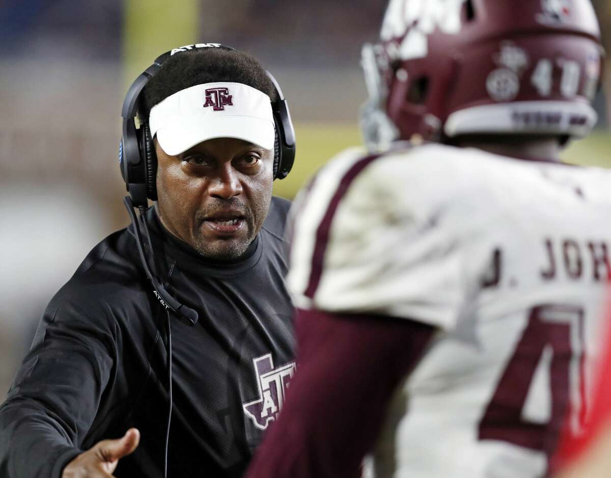 Texas A&M head coach Kevin Sumlin congratulates defensive lineman Jarrett Johnson (40) for helping stop Mississippi from getting a first down during the second half of an NCAA college football game in Oxford, Miss., Saturday, Nov. 18, 2017. Texas A&M won 31-24. (AP Photo/Rogelio V. Solis)