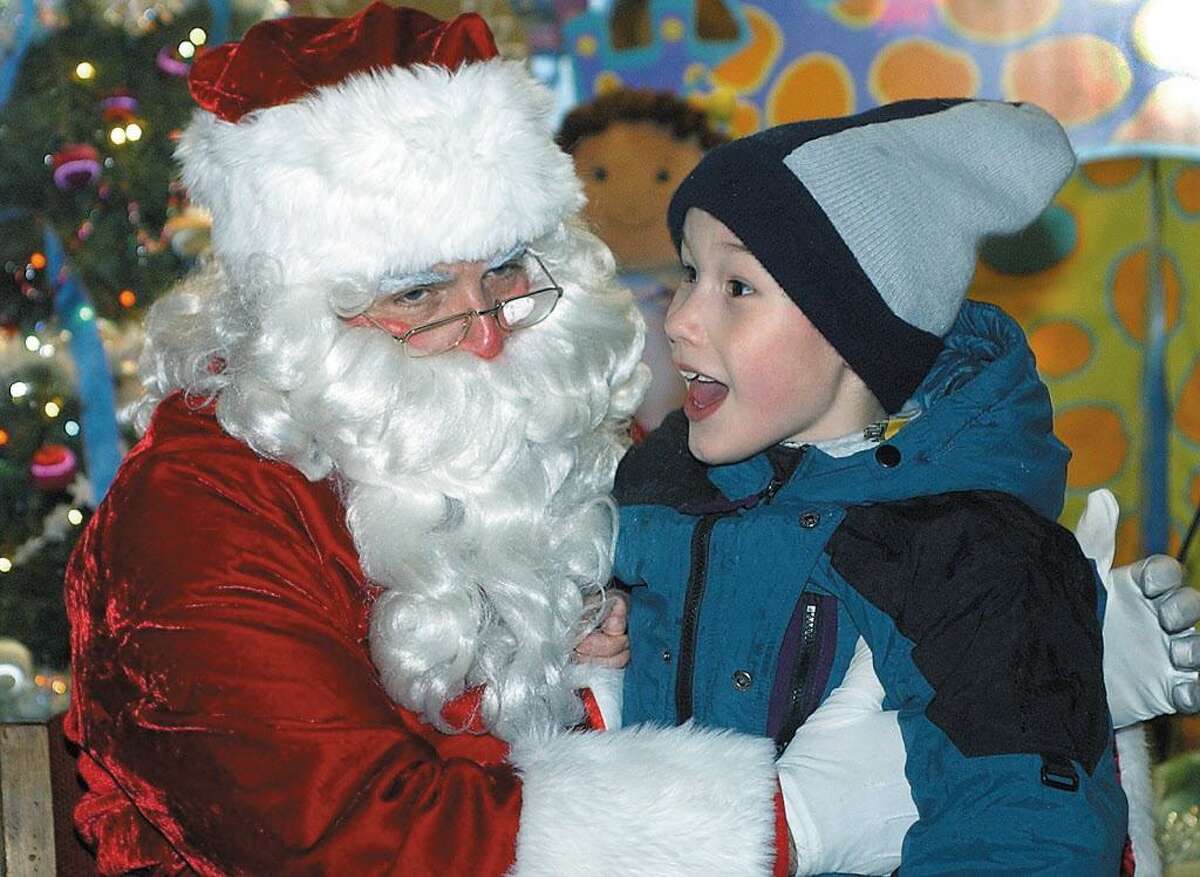 Rinat Reed of Middletown recounts his wish list to Santa (Al Santostefano) during Holiday on Main Street in this archive shot.