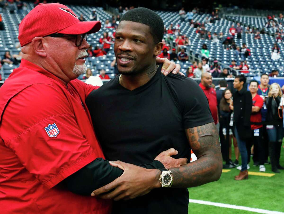 Arizona Cardinals head coach Bruce Arians embraces former Houston Texans wide receiver Andre Johnson before an NFL football game at NRG Stadium on Sunday, Nov. 19, 2017, in Houston.