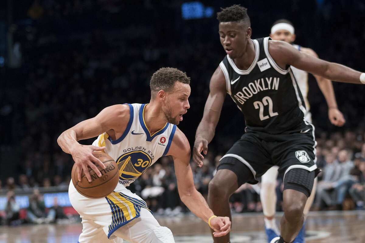 Golden State Warriors guard Stephen Curry (30) drives to the basket against Brooklyn Nets guard Caris LeVert (22) during the first half of an NBA basketball game, Sunday, Nov. 19, 2017, in New York. (AP Photo/Mary Altaffer)