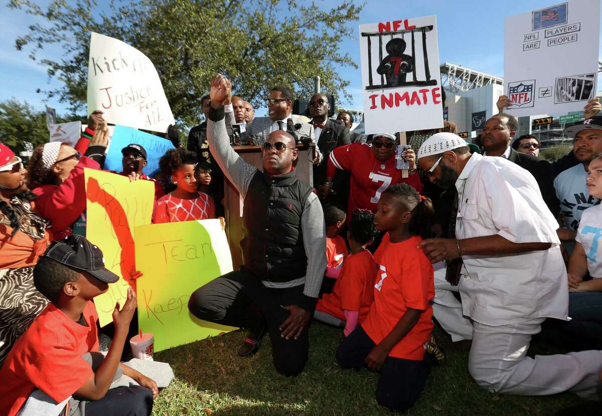 Protesters kneel to show their support to former San Francisco 49ers quarterback Colin Kaepernick on social issues and condemn Houston Texans owner Bob McNair for his "inmates" remark at NRG Parkway and Kirby Drive outside of NRG Stadium on Sunday, Nov. 19, 2017, in Houston. ( Yi-Chin Lee / Houston Chronicle )