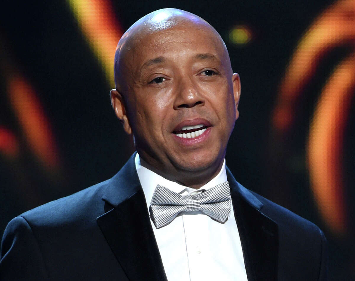 FILE - In this Feb. 6, 2015, file photo, hip-hop mogul Russell Simmons presents the Vanguard Award on stage at the 46th NAACP Image Awards in Pasadena, Calif. In a report published Sunday, Nov. 19, 2017, in the Los Angeles Times, Model Keri Claussen Khalighi accused Simmons of sexual misconduct in 1991 when she was 17-years-old. Simmons, denied the allegations in a statement.