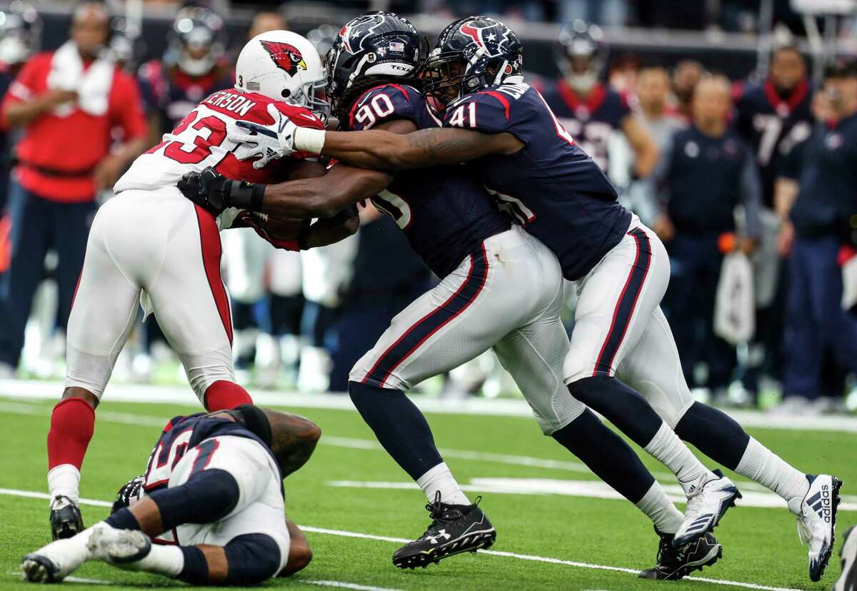 The Texans' Jadeveon Clowney, center, Zach Cunningham, right, and Benardrick McKinney worked to hold running back Adrian Peterson to 26 yards on 14 carries. ﻿