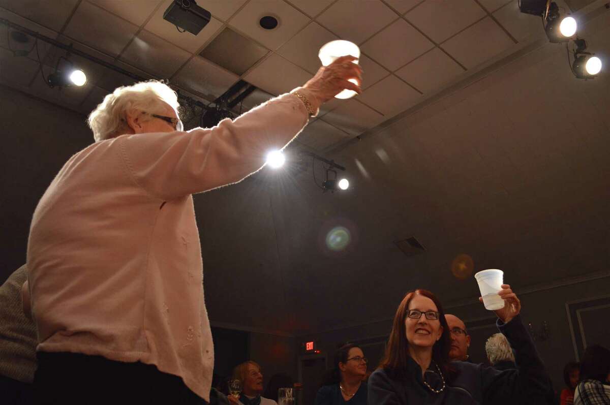 Audience members toast the 30th anniversary of the Clan Na Gael Players after their performance of "It's a Wonderful Life" at the Gaelic American Club, Friday, Nov. 17, 2017, in Fairfield, Conn.