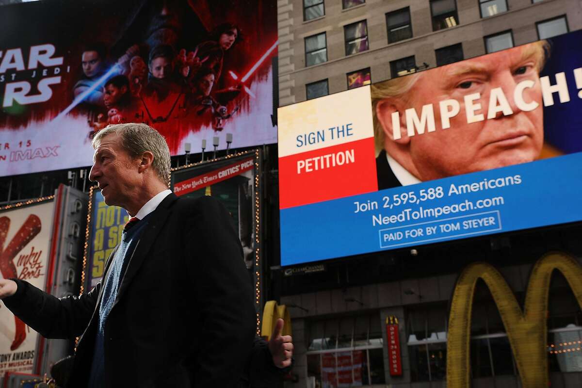 NEW YORK, NY - NOVEMBER 20: Philanthropist Tom Steyer stands in front of one of the billboards he has funded in Times Square calling for the impeachment of President Donald Trump on November 20, 2017 in New York City. Steyer, an American hedge fund manager, environmentalist, progressive activist, and fundraiser has pledged $20 million for an ad campaign urging for the impeachment of President Donald Trump. The billboards will go up in various locations across the United States. (Photo by Spencer Platt/Getty Images)