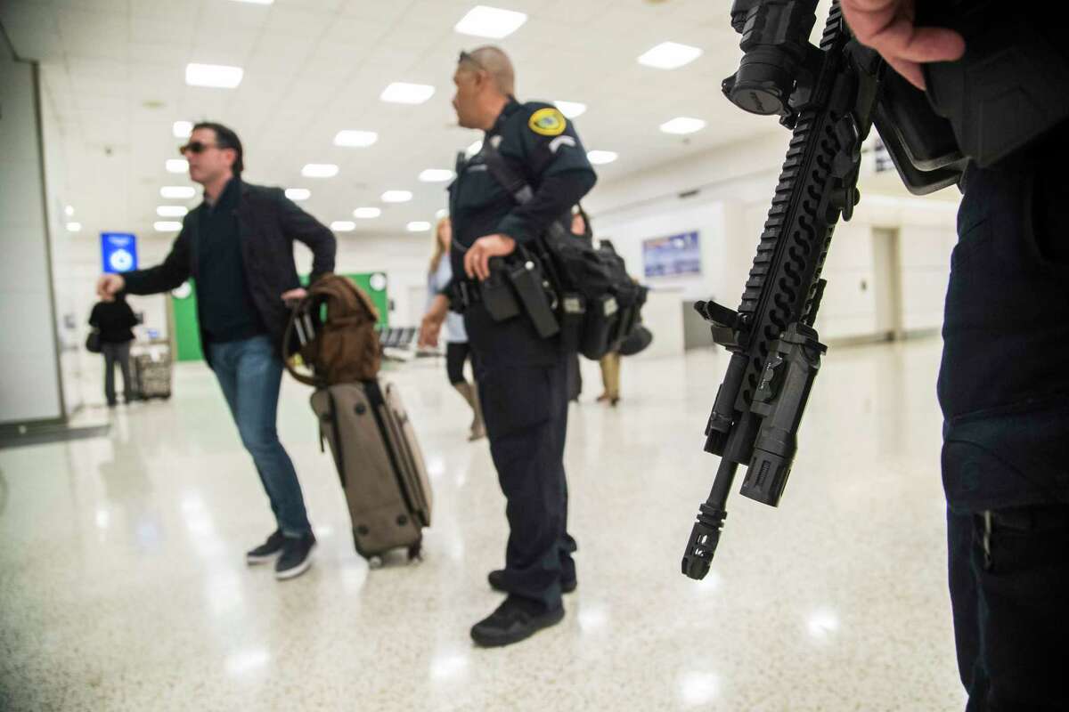 Houston Police Department officers walk the George Bush Intercontinental Airport carrying AR-15 rifles, Monday, Nov. 20, 2017, in Houston. They say the travelers have all given positive feedback. ( Marie D. De Jesus / Houston Chronicle )