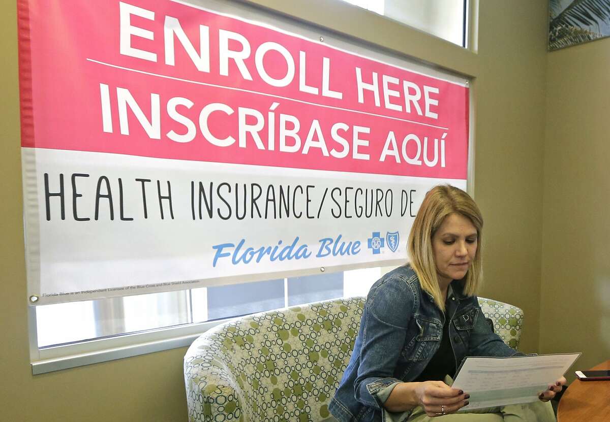 Catherine Reviati reviews the different Affordable Care Act enrollment options, Thursday, Nov. 2, 2017, in Hialeah, Fla. Health care advocacy groups are making an against-all-odds effort to sign people up despite confusion and hostility fostered by Republicans opposed to former President Barack Obama's signature domestic policy achievement. (AP Photo/Alan Diaz)