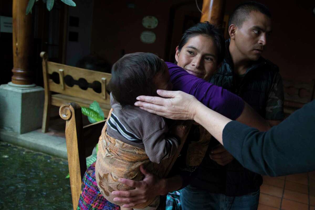 Linda McCarty extends her hand to caress Victor Hernandez Sica while his mother Juana Sica Juarez holds him at the Casa de Fe, where the family is staying while Victor receives care at the hospital. Thursday, Oct. 5, 2017, in Antigua. ( Marie D. De Jesus / Houston Chronicle )