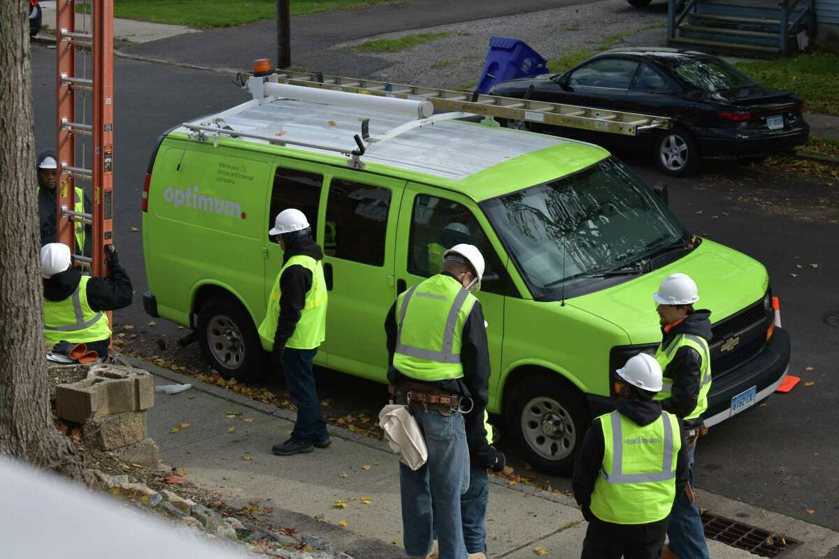 Optimum workers ready to perform line work on Friday, Nov. 10, 2017, on School Street in Norwalk, Conn. just up the street from the company's customer service office on Cross Street.