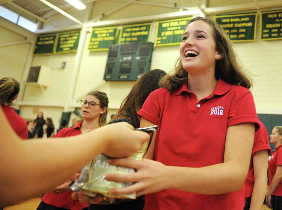 Jane Watson, then a senior, takes a food donation from an underclassman at the annual Ingathering at Greenwich Academy in 2017. Watson died in September and a memorial service to celebrate her life is planned later this month. 