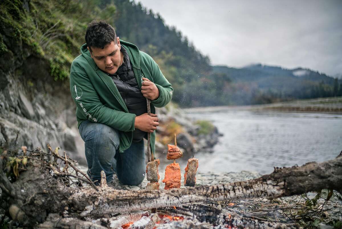 Sammy Gensaw prepares salmon filets next to the Klamath River on the Yurok Reservation on Thursday, Nov. 2, 2017.