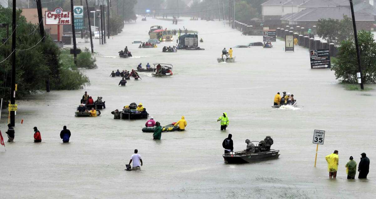 Rescue boats fill a flooded street as flood victims are evacuated as floodwaters from Tropical Storm Harvey rise in Houston on Aug. 28, 217. (AP Photo/David J. Phillip File)