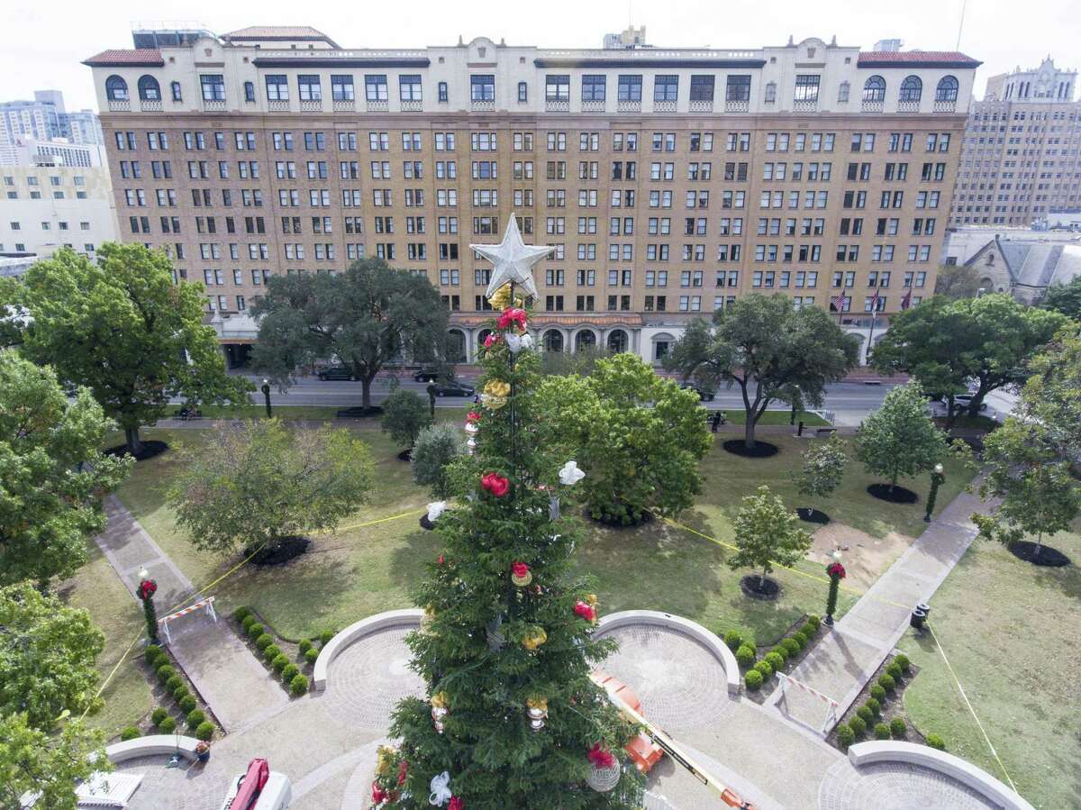 The 55-foot San Antonio Christmas tree stands Tuesday, Nov. 21, 2017 in the middle of Travis Park, with the St. Anthony hotel in the background. The holiday tree was moved to Travis Park from Alamo Plaza after the Confederate soldier monument was removed from the park and in anticipation of changes coming to Alamo Plaza with proposed redevelopment of the area.