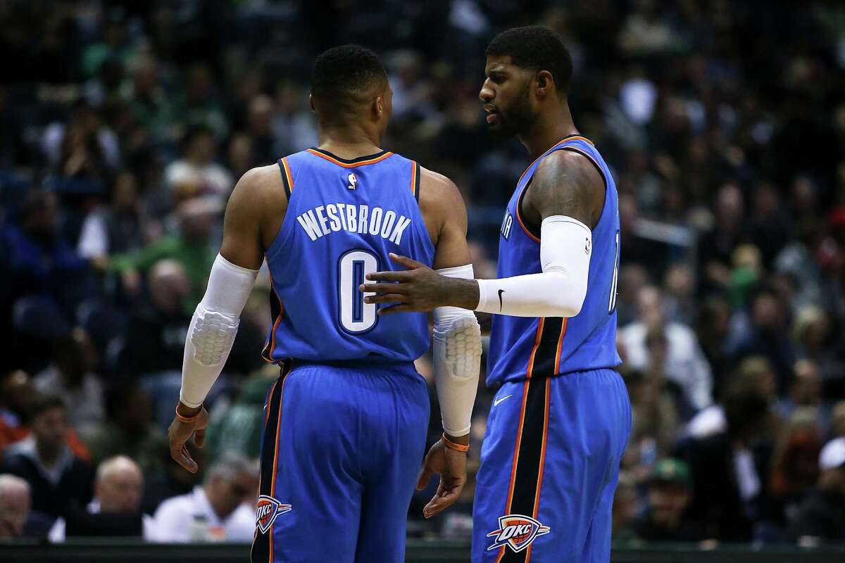 MILWAUKEE, WI - OCTOBER 31: Russell Westbrook #0 and Paul George #13 of the Oklahoma City Thunder meet in the third quarter against the Milwaukee Bucks at the Bradley Center on October 31, 2017 in Milwaukee, Wisconsin. NOTE TO USER: User expressly acknowledges and agrees that, by downloading and or using this photograph, User is consenting to the terms and conditions of the Getty Images License Agreement. (Photo by Dylan Buell/Getty Images)