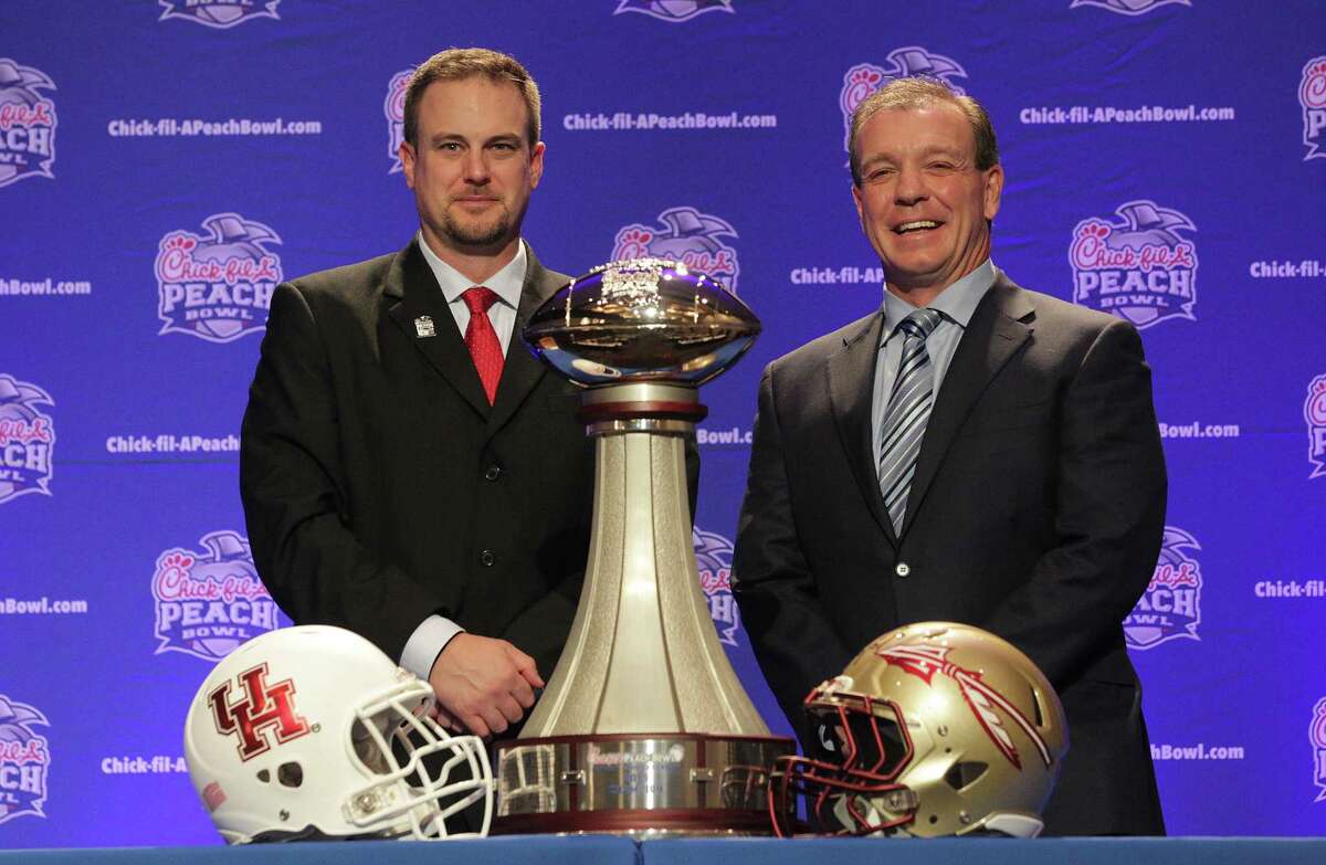 Houston Cougars head coach Tom Herman and Florida State University head coach Jimbo Fisher pose with the Chick-fil-A Peach Bowl trophy on Wednesday, Dec. 30, 2015, in Atlanta. ( Elizabeth Conley / Houston Chronicle )