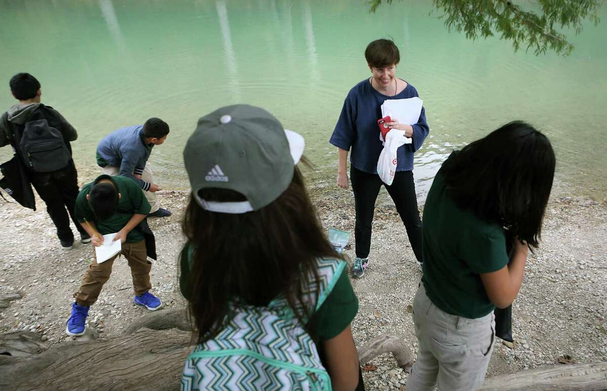 Joey Fauerso, a Texas State University art professor who has been commissioned to paint a mural, shows a group of fourth-graders from Cotton Academy the river during a nature appreciation field trip to Guadalupe River State Park, on Nov. 2, 2017. Fauerso was gathering ideas and words from the students for the mural.