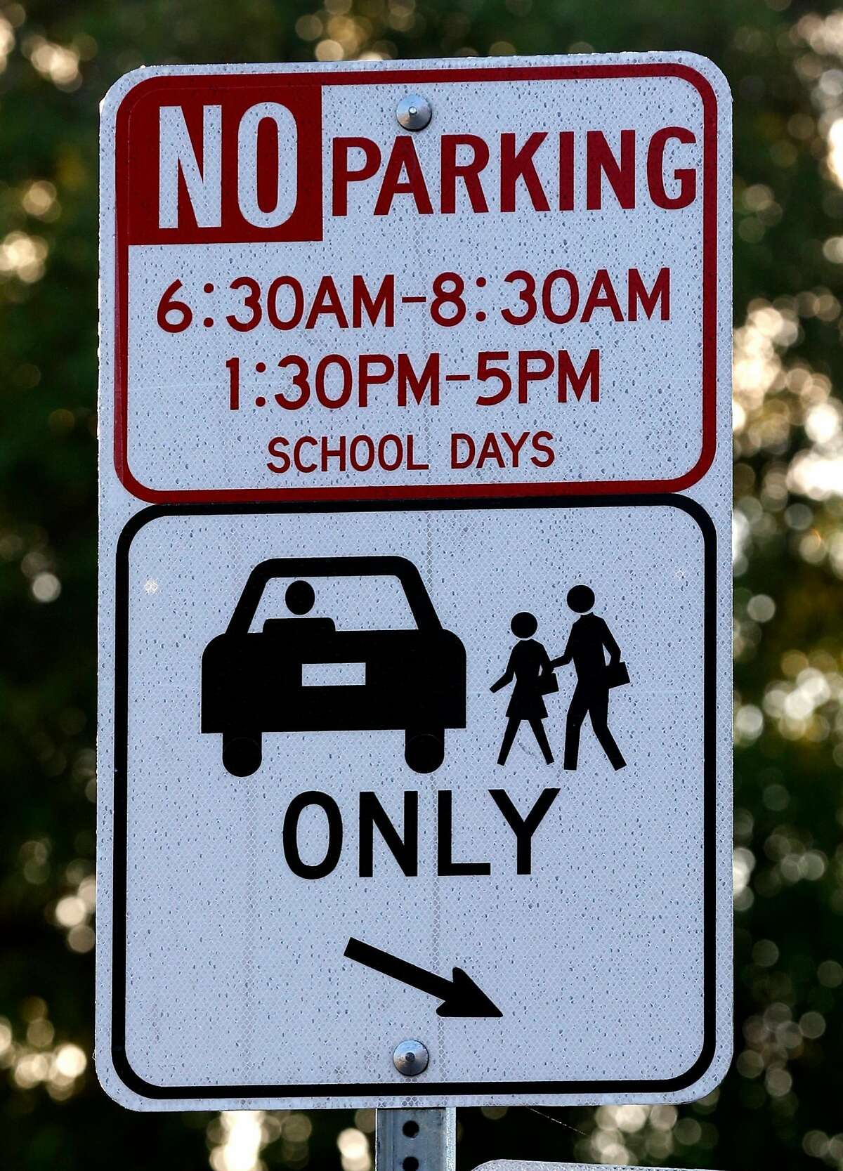 A special drop-off zone is designated for parents of Glenview Elementary School students on East 38th and Beaumont avenues in Oakland, Calif. on Friday, Nov. 17, 2017. Students are being bused to Santa Fe Elementary in North Oakland during reconstruction of their school. Delays and increased costs in the reconstruction of Glenview Elementary have angered parents and residents.