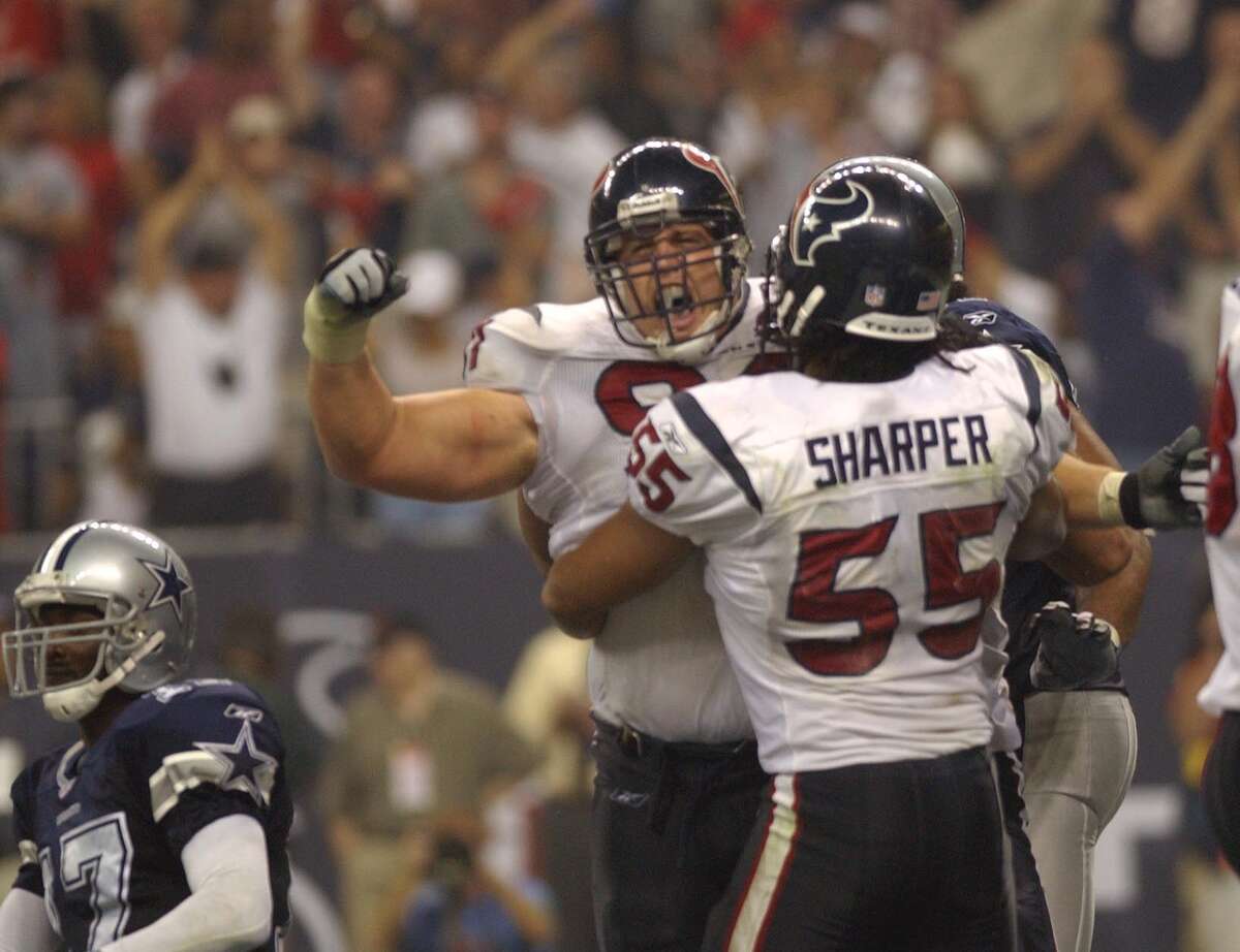 Texans defenders Seth Payne and Jamie Sharper celebrate after Payne sacked Cowboys quarterback Quincy Carter for the clinching safety during the Texans' 19-10 win in their inaugural game Sept. 8, 2002.