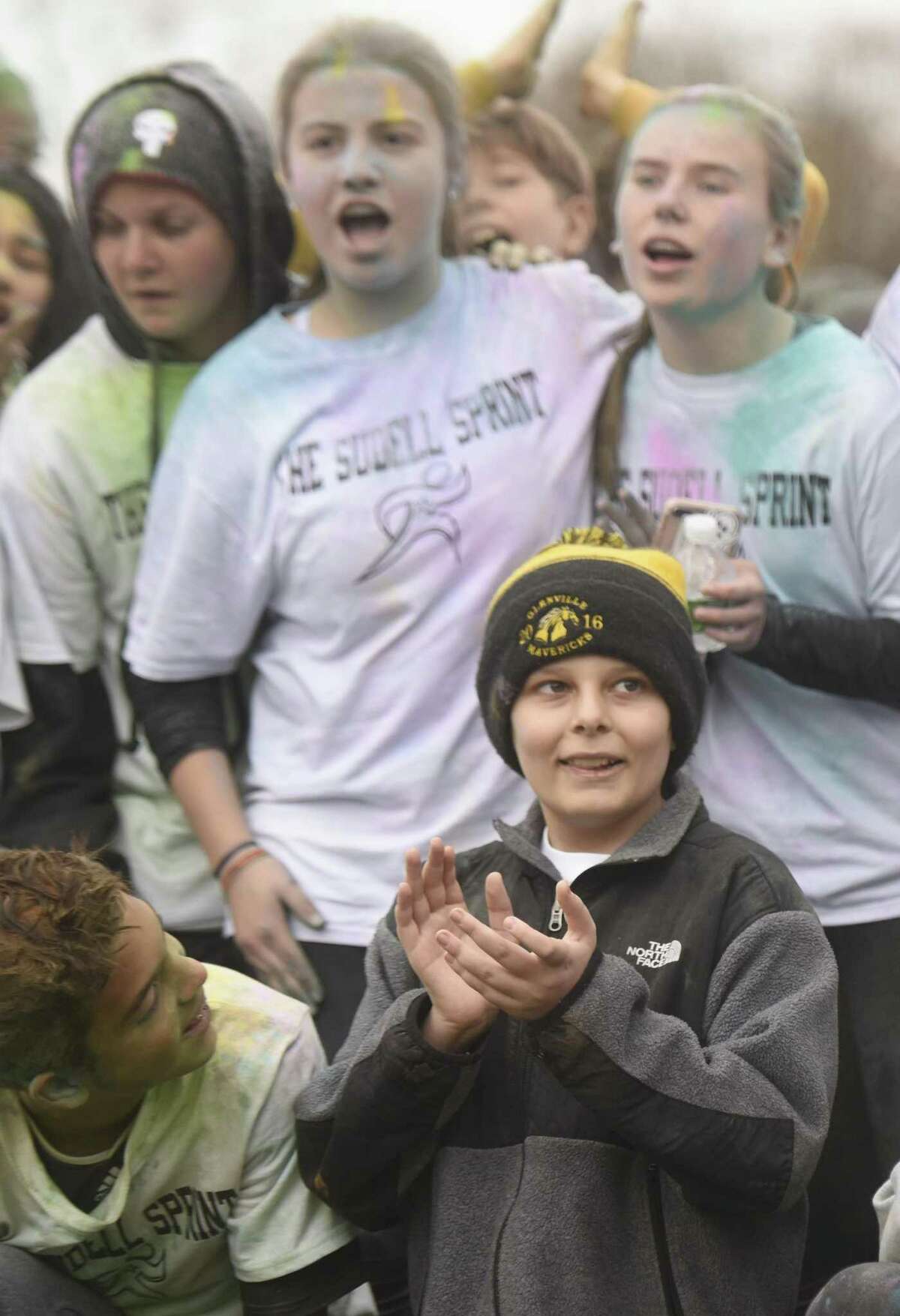Steven Sudell, an eighth-grader who is battling brain cancer, poses with his classmates after the Sudell Sprint color run at Western Middle School in Greenwich, Conn. Wednesday, Nov. 22, 2017. Eighth-graders raised $8,000 for the family of Steven Sudell and put on a color run from the school to Hamill Rink in his honor with a pizza and ice cream party afterwards.