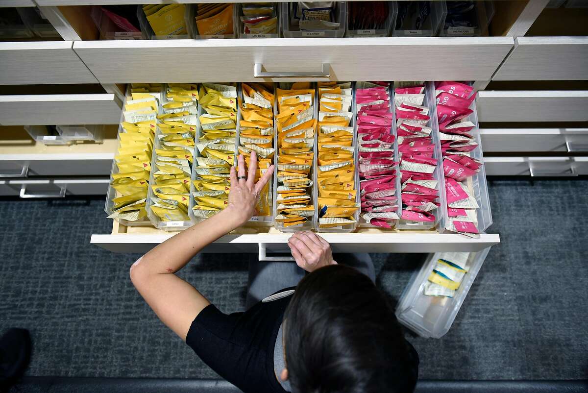 Patient consultant Melissa Zoppa restocks drawers with edible cannabis products at medical cannabis dispensary The Apothecarium in San Francisco, CA, on Wednesday November 22, 2017.