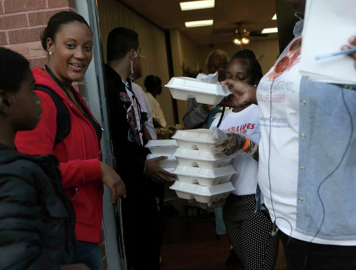 Thanksgiving meals are boxed and distributed to families during Kids Lives Matter's annual Thanksgiving community outreach event for more than 1,500 less fortunate children and families at Cuney Homes Apartments on Wednesday, Nov. 22, 2017, in Houston. ( Elizabeth Conley / Houston Chronicle )