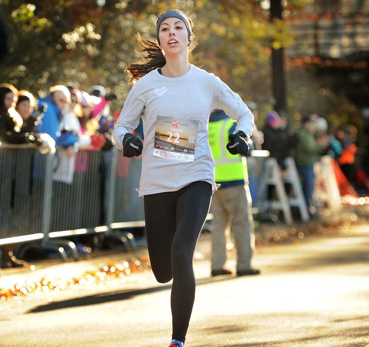 Haley Abing, of Boston, crosses the finish line as the women's winner of the annual Pequot Runners 5-mile Thanksgiving Day Road Race in Fairfield, Conn. on Thursday, November 23, 2017. Over 4000 runners registered for this year's race.