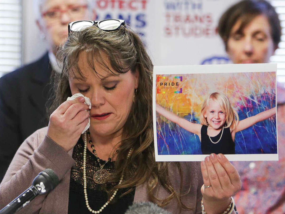 Kimberly Shappley holds a photo of her daughter, Kai Shappley, who is transgender, during a press conference at the Montrose Center where community leaders react to the news that Donald Trump is expected to roll back Obama era regulations that protect transgender people Thursday, Feb. 23, 2017 in Houston. ( Michael Ciaglo / Houston Chronicle )