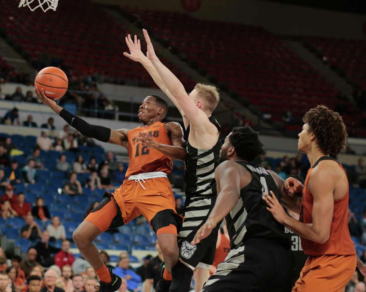 Texas guard Kerwin Roach, left, gets past a Butler defender on his way to the basket in the second half of Thursday's game in Portland, Ore.