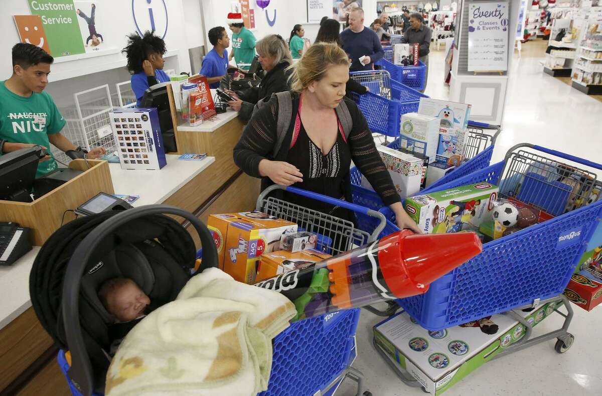 Missy McCauley of Martinez checks out at the Concord Toys R Us, which opened at 5 p.m. on Thanksgiving.