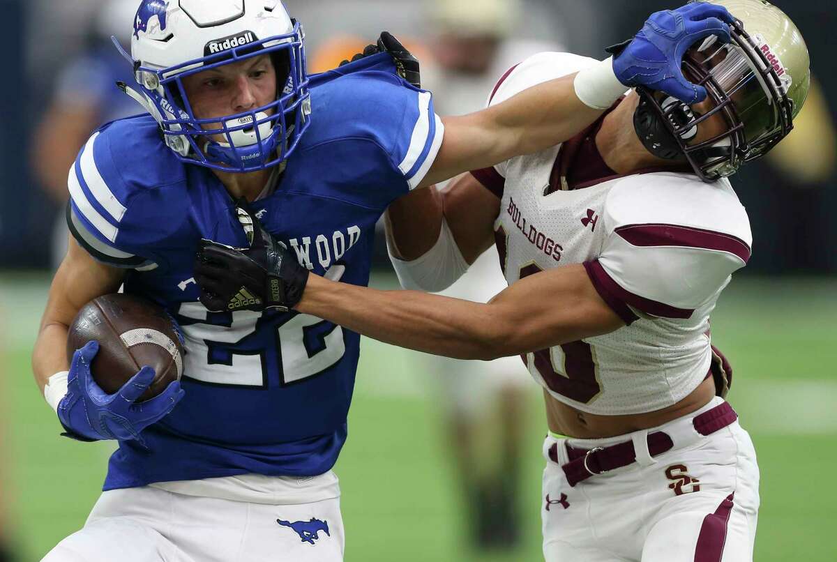 Friendswood's Mason Barnes, left, gives Summer Greek's Joseph Tucker a stiff-arm during the second quarter of the Class 6A Division 2 Area Playoffs game at NRG Stadium on Friday, Nov. 24, 2017, in Houston.