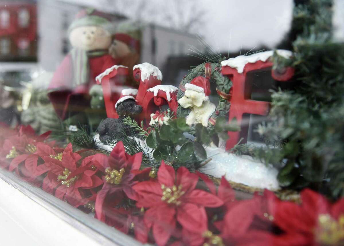 Festive holiday dog statues sit in the window of Professional Dog Grooming in Byram Monday, Dec. 12, 2016. Professional Dog Grooming won the Greenwich Chamber of Commerce's holiday window decorating award for Byram.