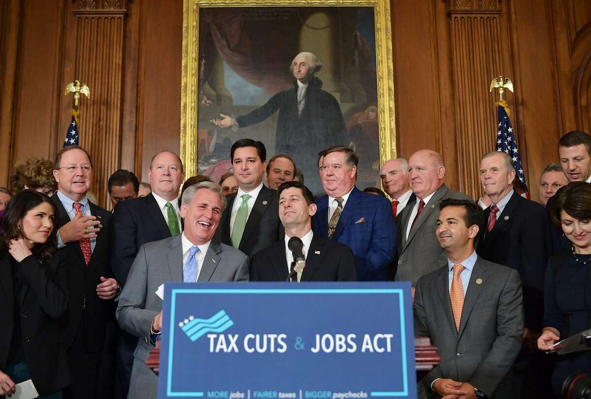 House Majority Leader Kevin McCarthy laughs with House Speaker Paul Ryan (center) during a press conference after the House passed its version of the Republican tax overhaul this month.