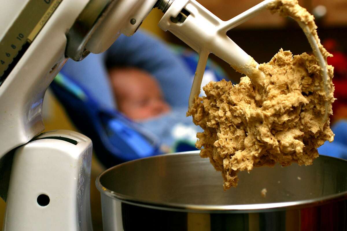 FILE - In this undated file photo, cookie dough clings to the beaters of a standing mixer. The Food and Drug Administration issued a warning on June 28, 2016, that people shouldn't eat raw dough due to an ongoing outbreak of illnesses related to a strain of E. coli bacteria found in some batches of flour. (AP Photo/Larry Crowe, File)