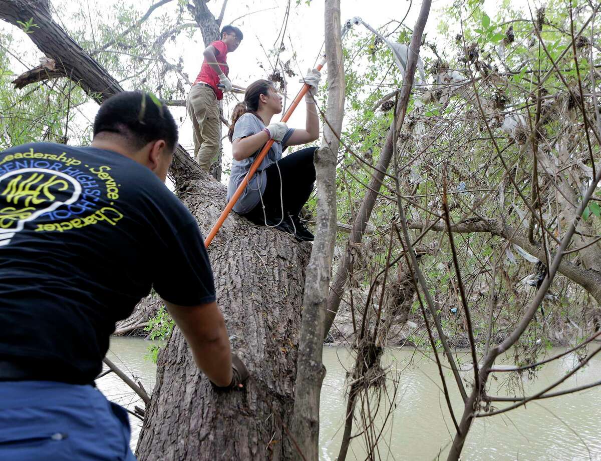 Duyen Nguyen, 18, cleans off debris from a tree left byHarvey at Buffallo Bayou trails and park on Saturday, Nov. 18, 2017, in Houston. According to officials, over 160 volunteers have been showing up a every weekend since September to help with the clean up efforts. To find a calendar or check on volunteer opportunities at the park, contact them through their website. ( Elizabeth Conley / Houston Chronicle )