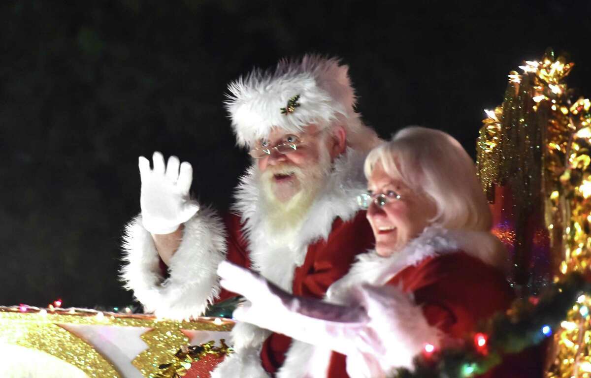 Santa and Mrs Clays wave to the crowd during the 36th Annual Ford Holiday River Parade Friday evening. The parade features 28 illuminated floats decorated for the theme Christmas at the Movies with over 50,000 people expected to attend.