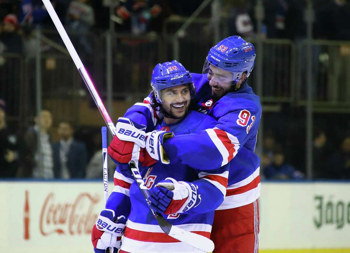 NEW YORK, NY - NOVEMBER 24: (l-r) Mats Zuccarello #36 celebrates his goal at 37 seconds of overtime against the Detroit Red Wings and is joined by Mika Zibanejad #93 of the New York Rangers (r) at Madison Square Garden on November 24, 2017 in New York City. The Rangers defeated the Red Wings 2-1 in overtime. (Photo by Bruce Bennett/Getty Images) ORG XMIT: 775040890