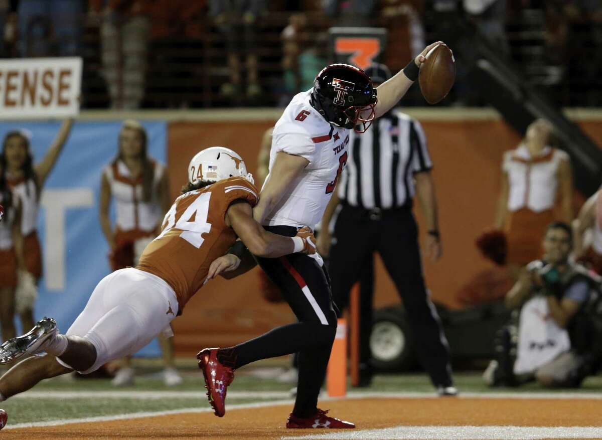 AUSTIN, TX - NOVEMBER 24: McLane Carter #6 of the Texas Tech Red Raiders rushes for a touchdown in the first quarter defended by John Bonney #24 of the Texas Longhorns at Darrell K Royal-Texas Memorial Stadium on November 24, 2017 in Austin, Texas. (Photo by Tim Warner/Getty Images)