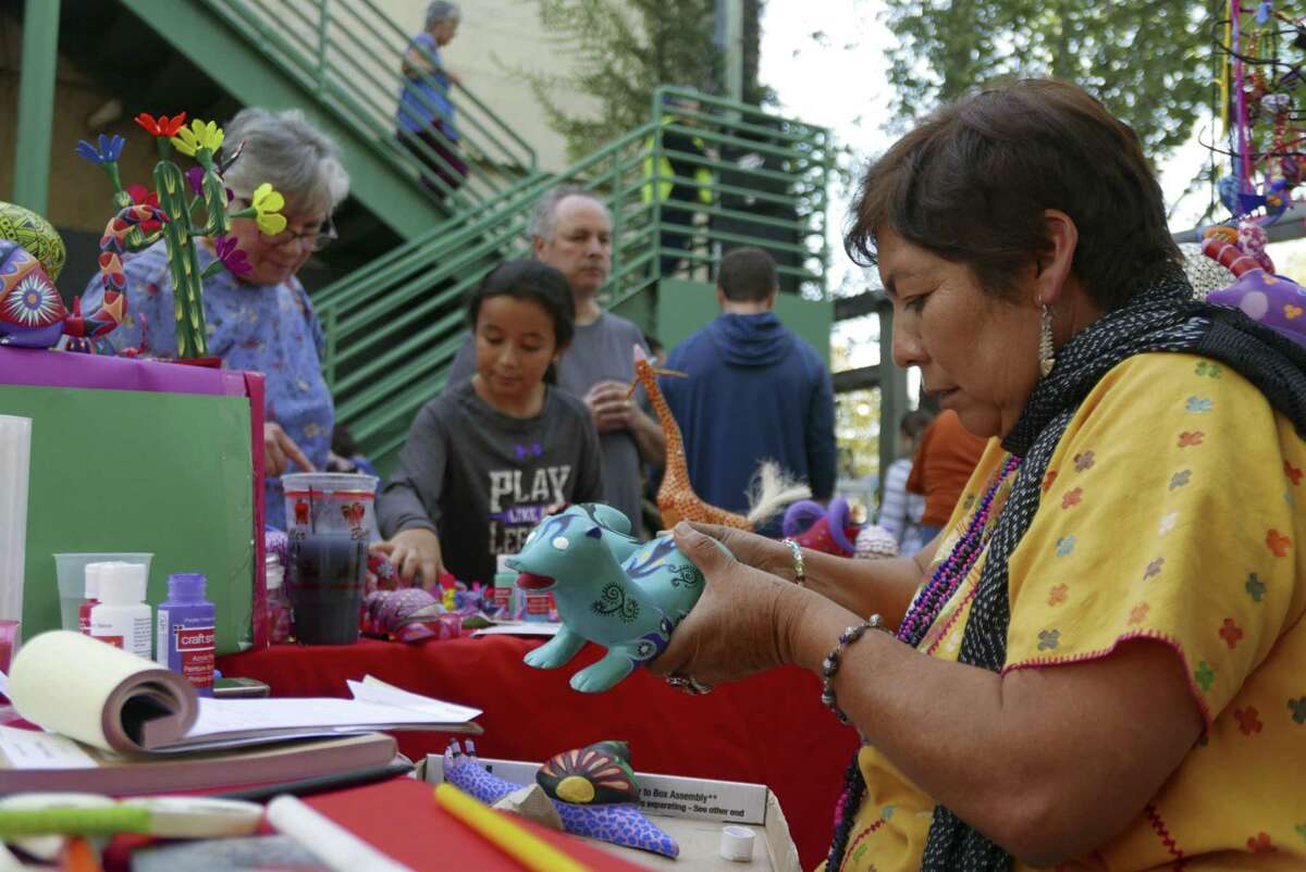 Cristina Antonio Herrera, who is from the municipality of Arrazolaxoxo in the Mexican state of Oaxaca, paints an alebrije, a kind of fantasy creature, at the annual International Peace Market at the Esperanza Peace & Justice Center.