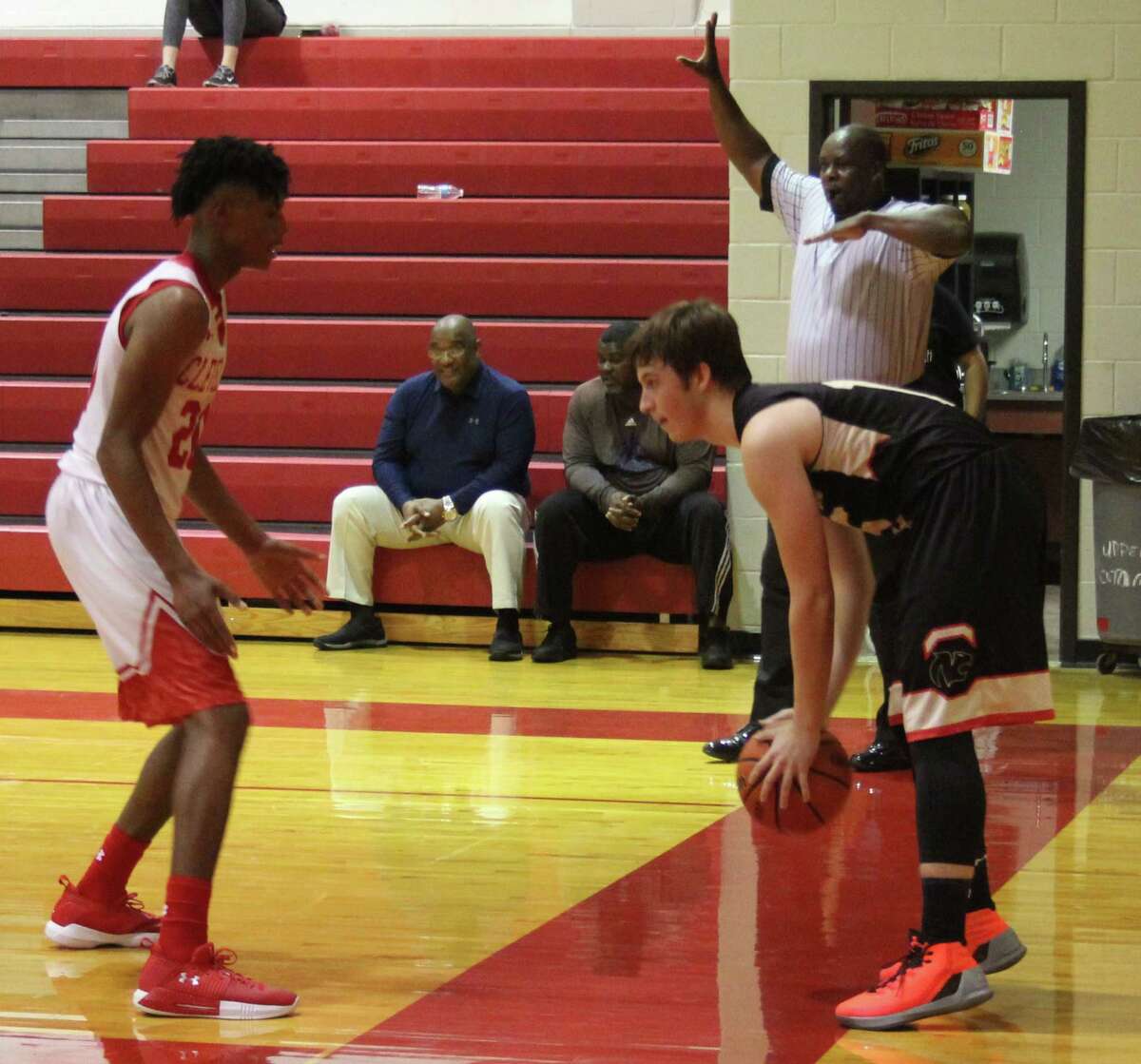 Chance Brown (left) of the Cleveland Indians blocks off a Northland Christian Cougar (right) who is preparing to bring the ball back into court.
