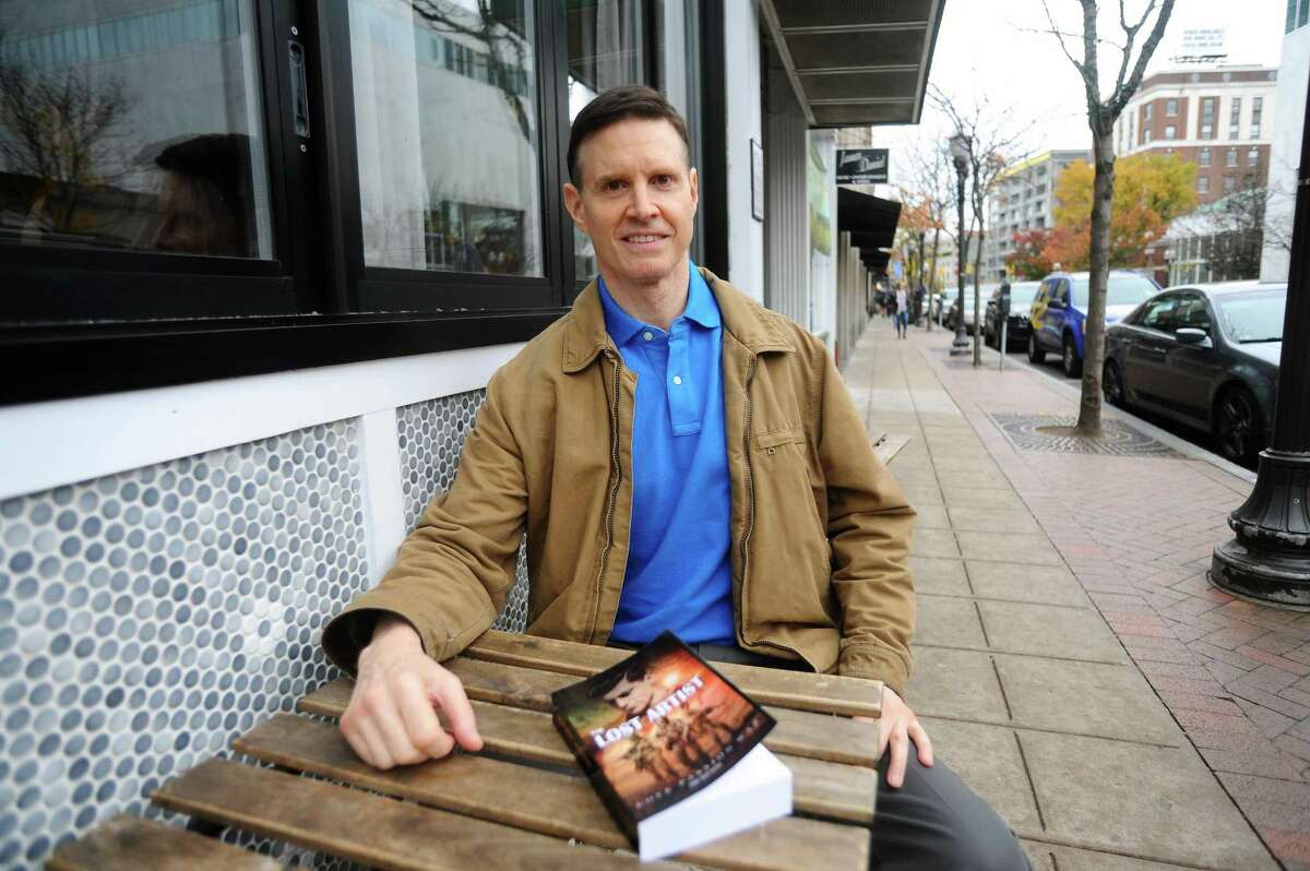 Eric Hausman-Houston poses for a photo outside Lorca on Bedford Street in downtown Stamford, Conn. on Wednesday, Nov. 1, 2017. Hausman-Houston recently wrote and published a book titled "The Lost Artist" about his grandfather who fled Nazi troops during WWII and then fought for the British army.