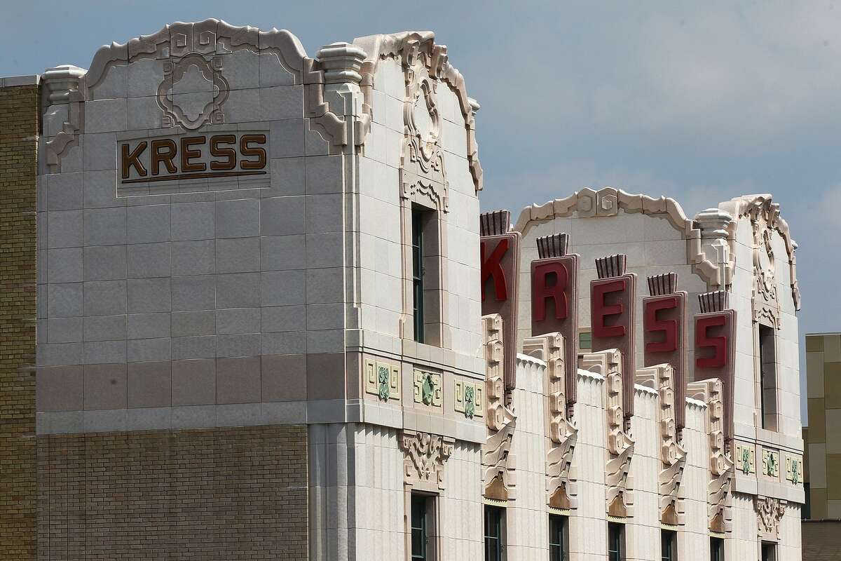 The sun lights the Art Deco features, such as the symmetrical towers, vertical lines and ornamentation, of the Kress Building.