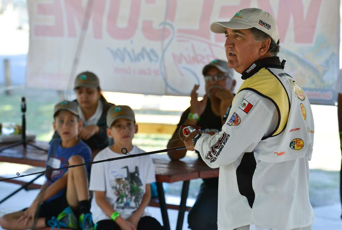 Pedro Sors of the Cana y Carrete fishing television show conducts a seminar Sunday at the southside Lions Park. Sors was explaining the basics of fishing during the seminar.