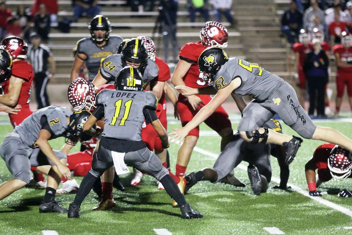 Panther junior Keaton Parker is airborne as he zooms in on a tackle of one of the Salador Eagle runners at the playoff game last Saturday in Bryan.