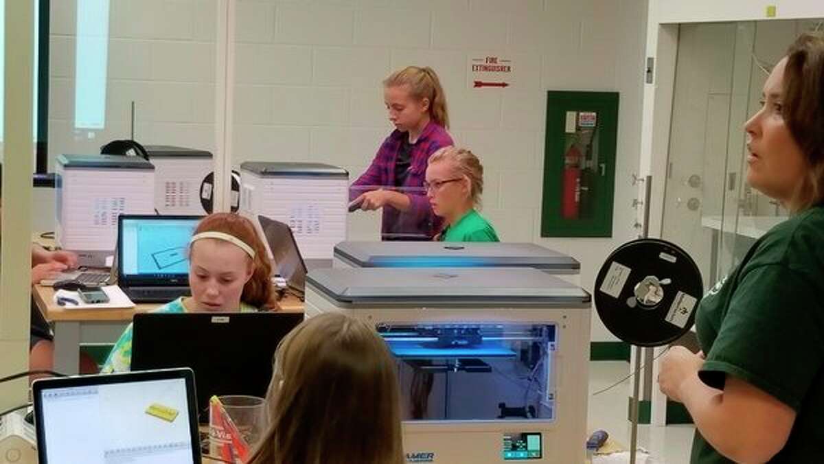 From left, Myah Zalusky, Adeline Doyle, Lauren McGuirk and teacher/advisor Jennifer Lenon visit Michigan State University St. Andrews, where they were introduced to 3D printing and underlying computer-aided design modeling through a 3D printing workshop. (Photo provided)