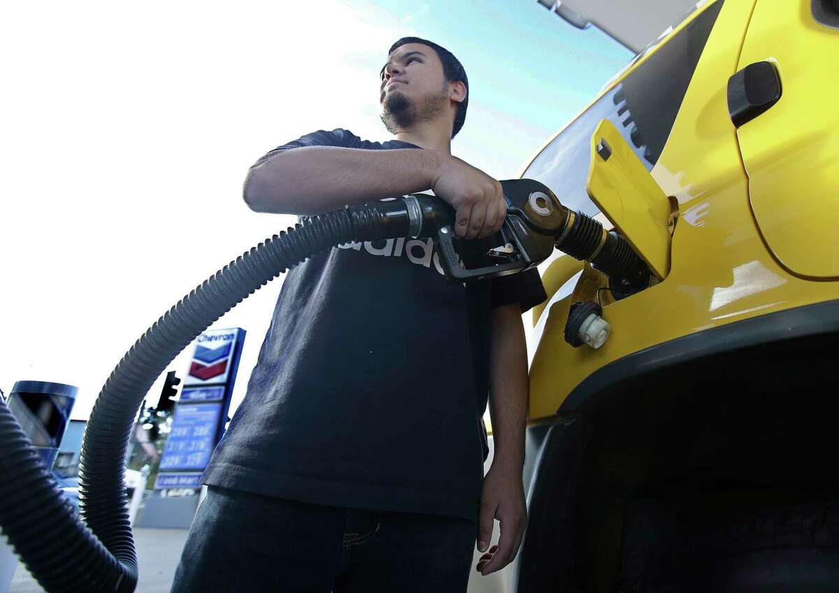 In this photo taken Monday, Oct. 30, 2017, Cristian Rodriguez fuels his vehicle, in Sacramento, Calif. Gasoline taxes will rise by 12 cents per gallon Wednesday, Nov., 1, to raise money for fixing roads and highways. It is the first of several tax and fee hikes that will take effect after they were approved by the Legislature earlier this year. (AP Photo/Rich Pedroncelli)