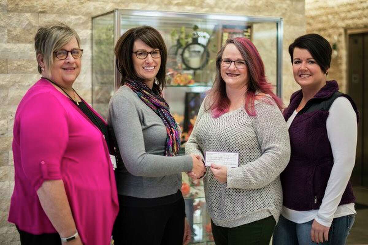 Danielle 'Dani' Blackhurst, owner of Dani B's Studio for Hair in Midland, recently presented a $225 check to Gina Stevens, manager of Imaging Services, MidMichigan Health. Individuals in need of breast health care are to benefit from the support. The funds were raised by customers who donated $5 to change a strand of Blackhurst's hair to pink. In total, $550 was raised with the remaining half given to Cancer Services of Midland. Also pictured are Nancy Aron, stylist at Dani B's, right, and Kathleen Ludwig, left, coordinator for the Breast Health Program, MidMichigan Health. MidMichigan Health offers free mammograms year round for individuals 40 and older who do not have insurance and have not had a screening mammogram in the past year. Those interested in more information may call Ludwig at 989-837-9070.