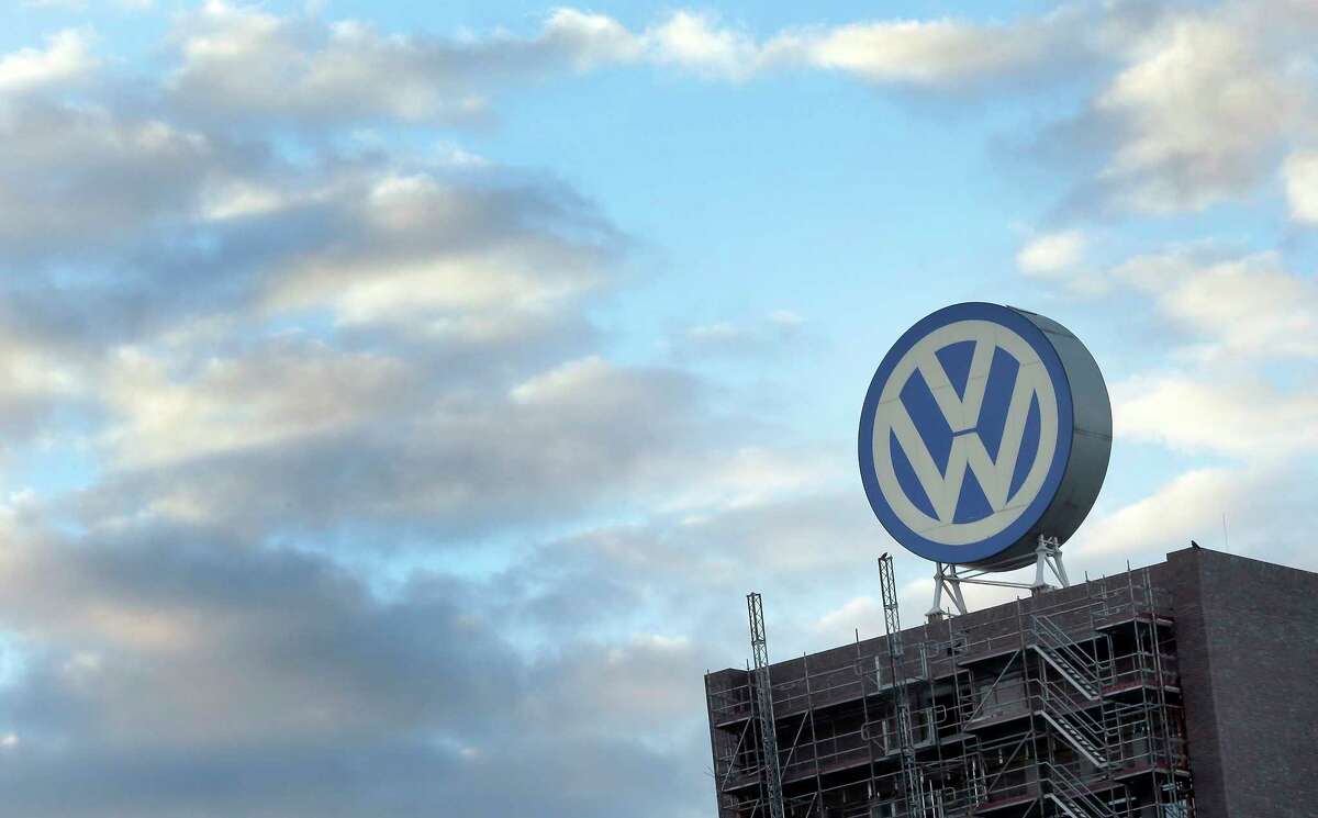 FILE - In this Sept. 26, 2015 file photo a giant logo of the German car manufacturer Volkswagen is pictured on top of a company's factory building in Wolfsburg, Germany. (AP Photo/Michael Sohn, file)