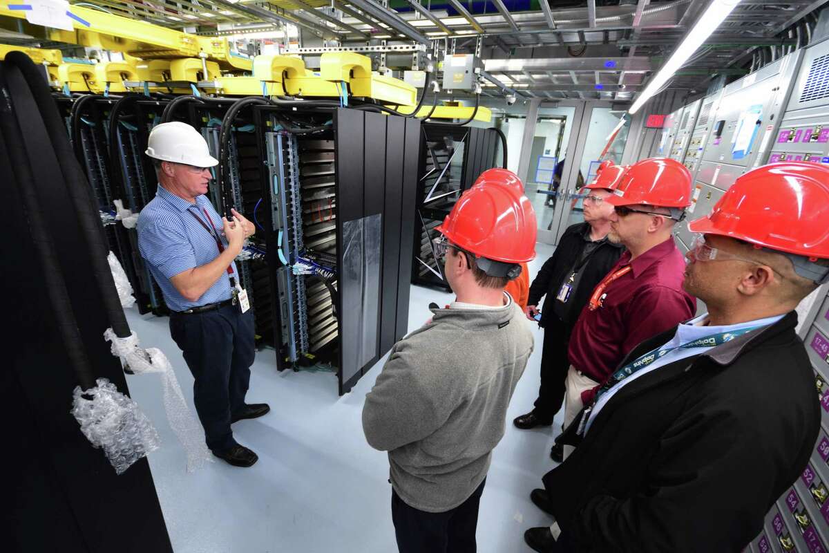 Visitors tour the Summit supercomputer at Oak Ridge National Lab as it nears completion.